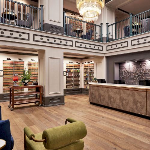 A luxurious reception area with chandeliers, ornate railings, and shelves packed with colorful products in a stylish interior.